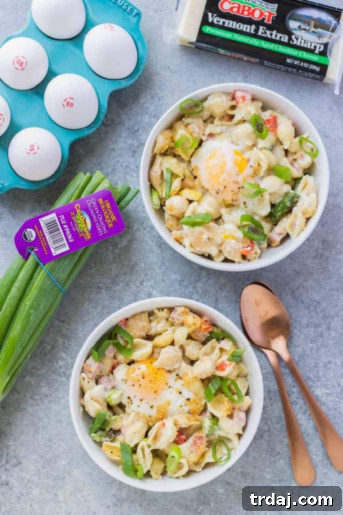 A vibrant display of fresh ingredients used in the Breakfast Macaroni and Cheese, including asparagus, ham, and cheese.