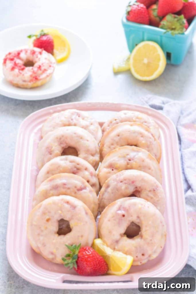 Experience the perfect blend of sweet strawberries and tangy lemonade in these homemade donuts. Delicious Baked Strawberry Lemonade Donuts Ready for Glazing