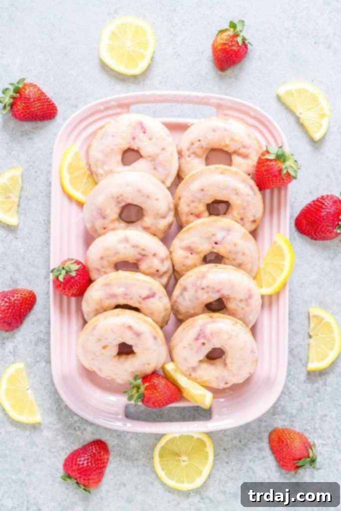 Enjoy these light, fluffy, and flavorful strawberry lemonade donuts for any occasion. Stacked Strawberry Lemonade Donuts, close-up of glaze and texture
