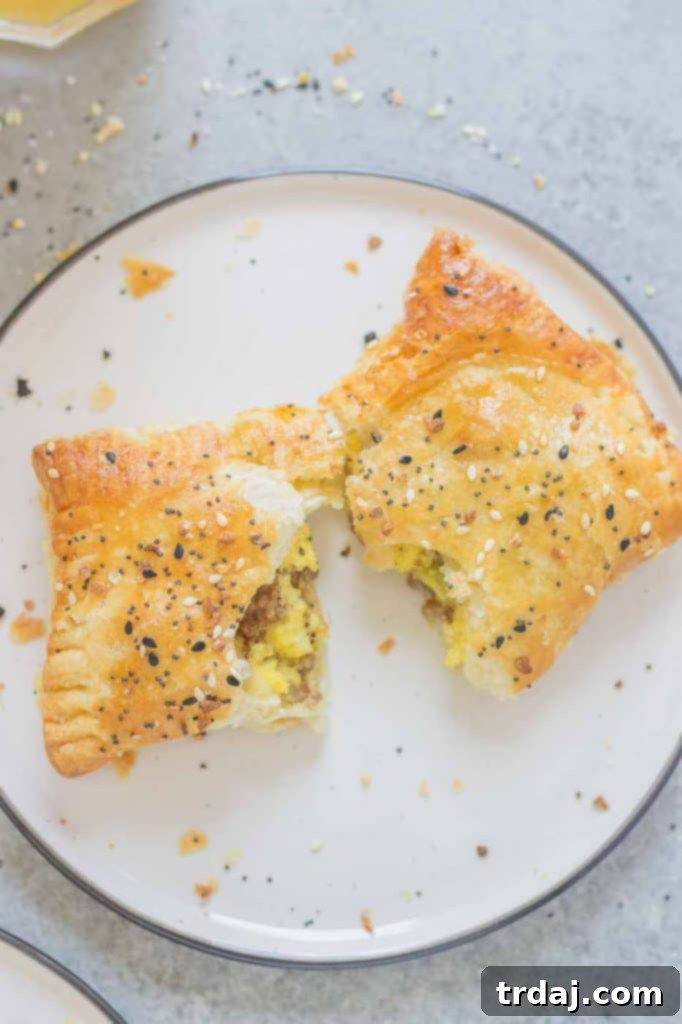 Hand holding a flaky Everything Bagel Breakfast Pocket