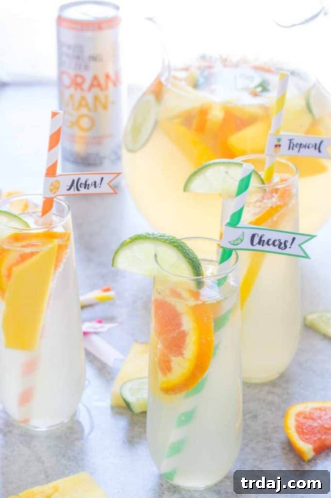 Tropical Orange Mango Sangria in pitcher with fresh fruit