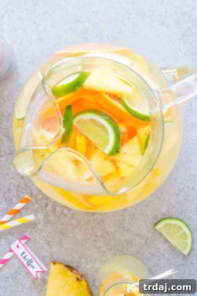 Tropical Orange Mango Sangria pitcher and glasses on a table