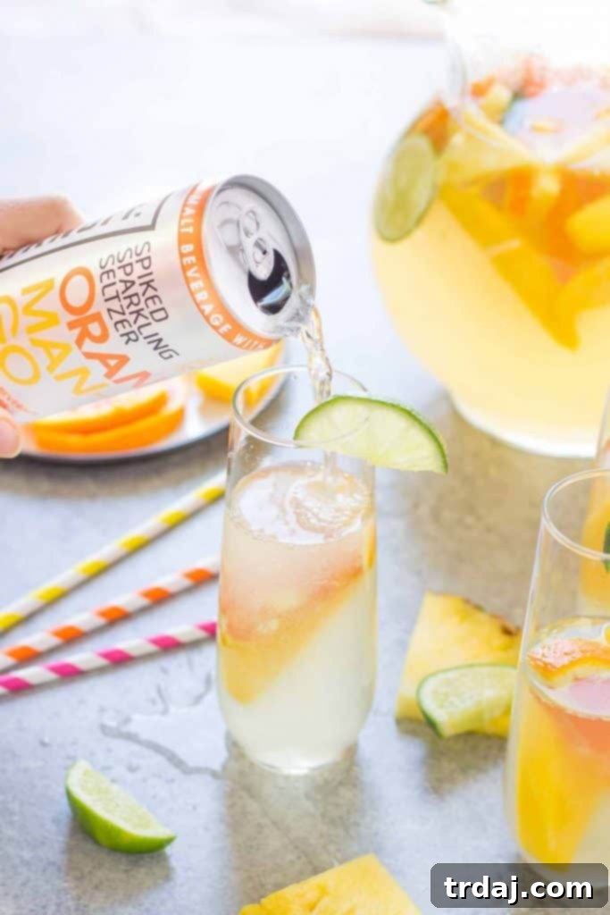 Glass of Tropical Orange Mango Sangria ready to enjoy