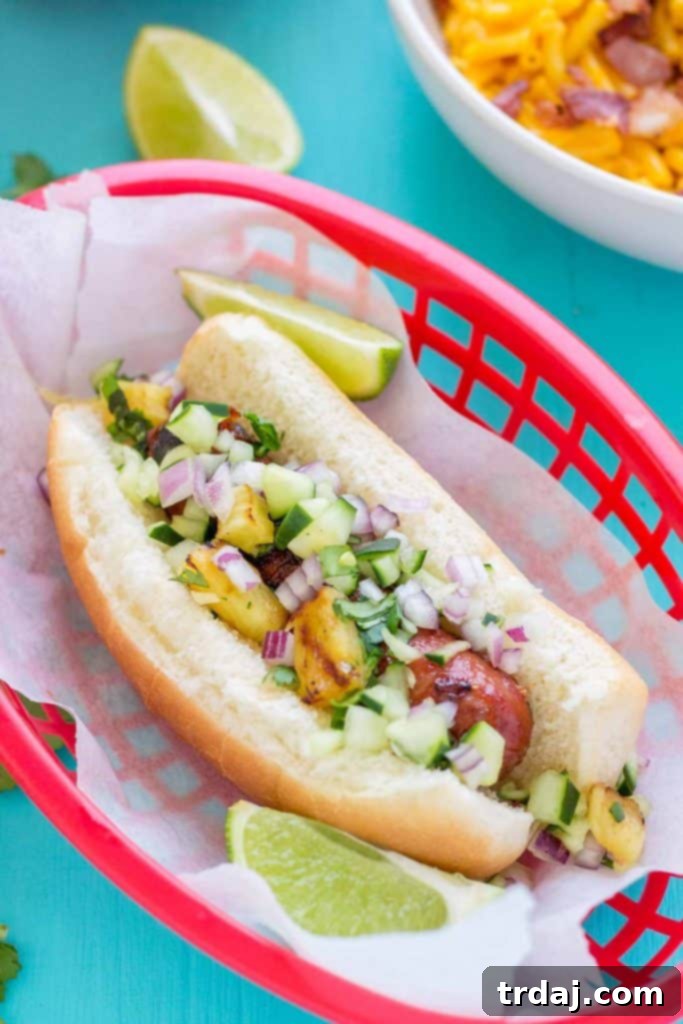 Hawaiian BBQ Hot Dogs with vibrant grilled pineapple cucumber salsa