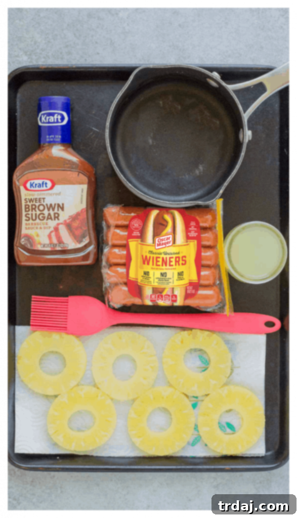 Hot dogs being basted with Hawaiian BBQ sauce on the grill