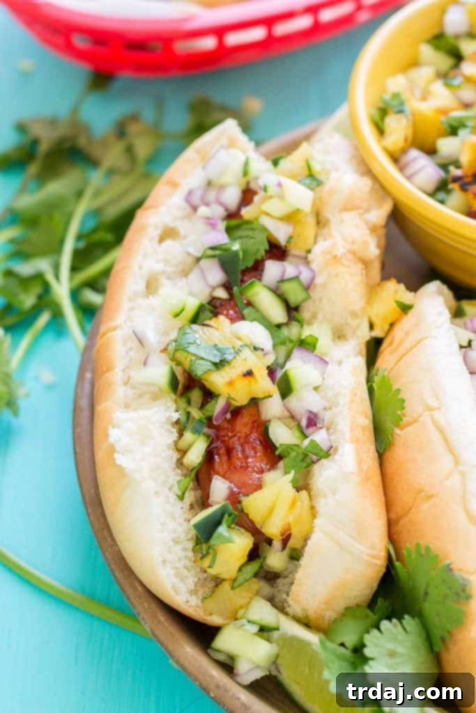 Hawaiian BBQ Hot Dogs served with grilled pineapple and cucumber salsa
