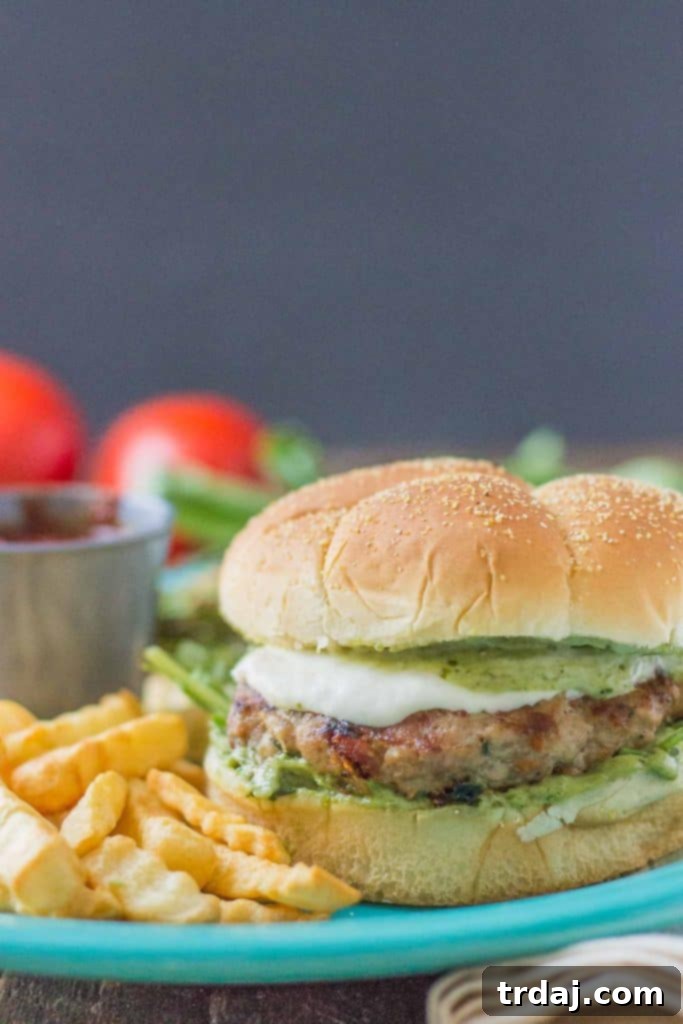 Pesto and Sun Dried Tomato Turkey Burgers with fresh basil, sun-dried tomatoes, and melted mozzarella.