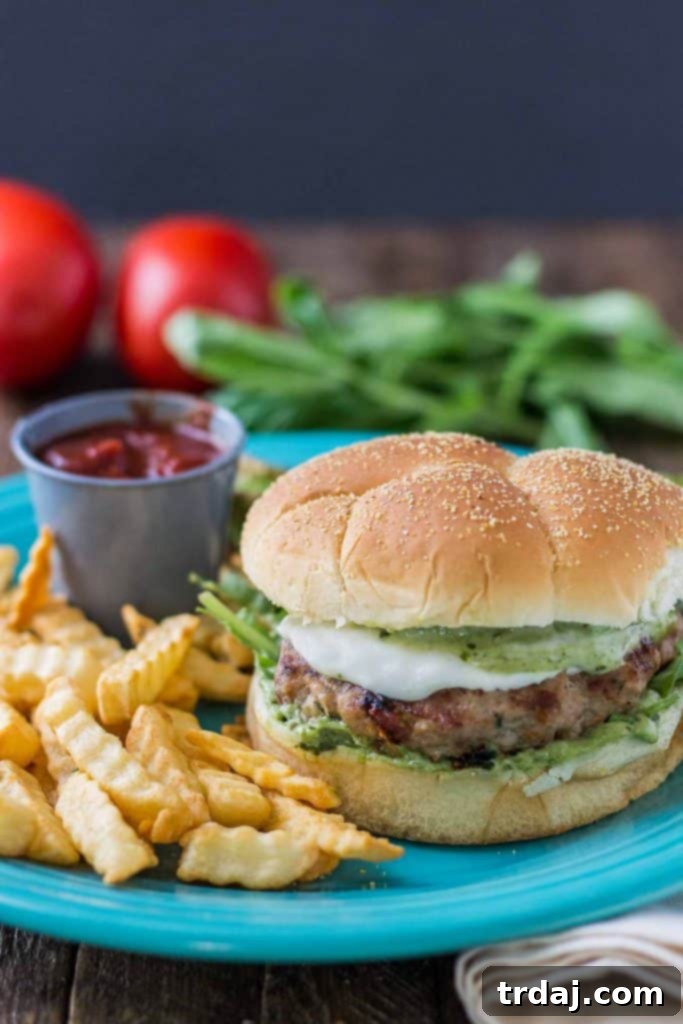 Raw Pesto and Sun Dried Tomato Turkey Burger patties, ready for grilling.